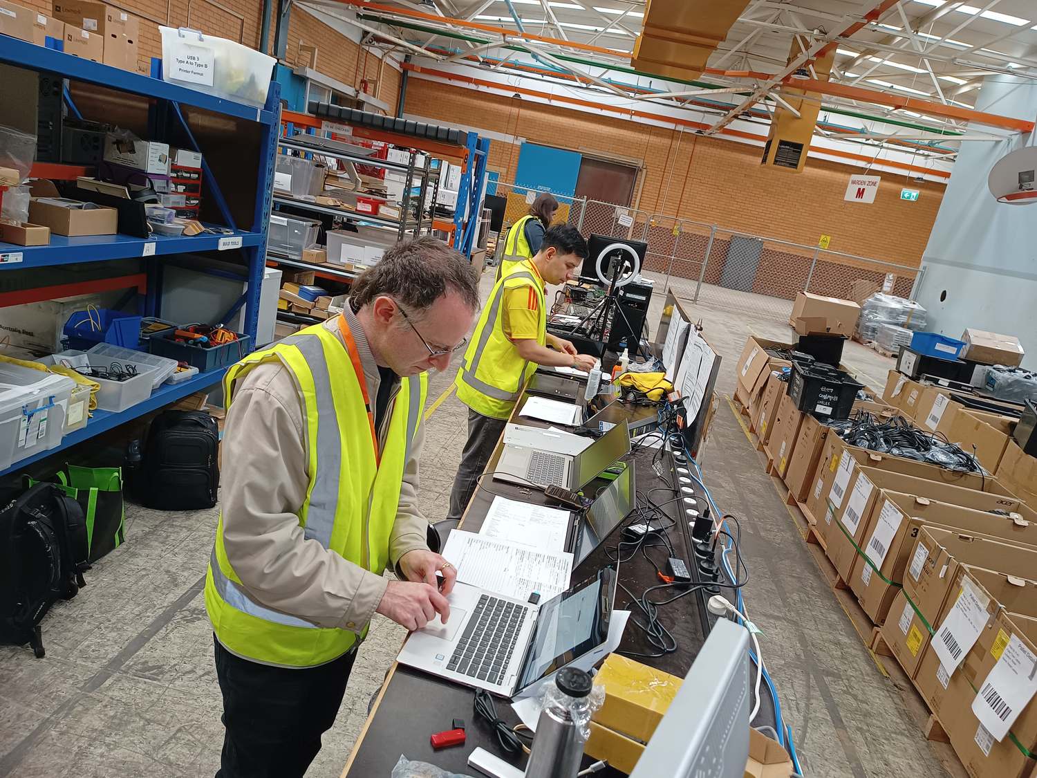 A volunteer testing a laptop at the build bench