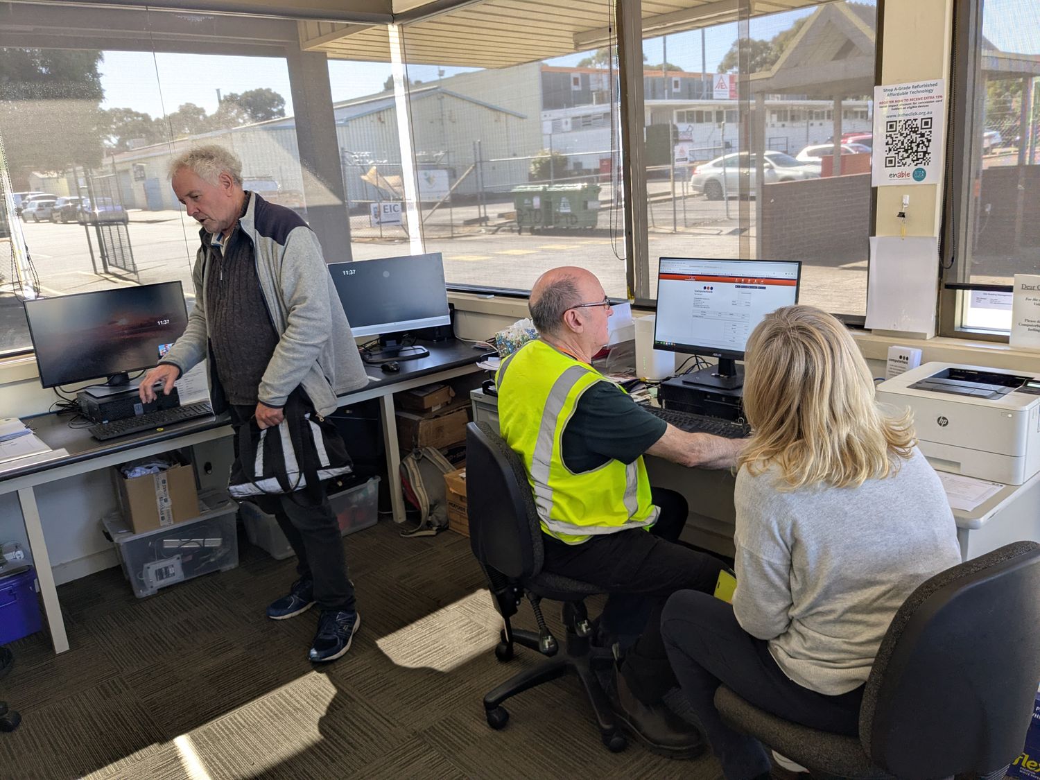 A front desk volunteer helping a customer at the Broadmeadows showroom