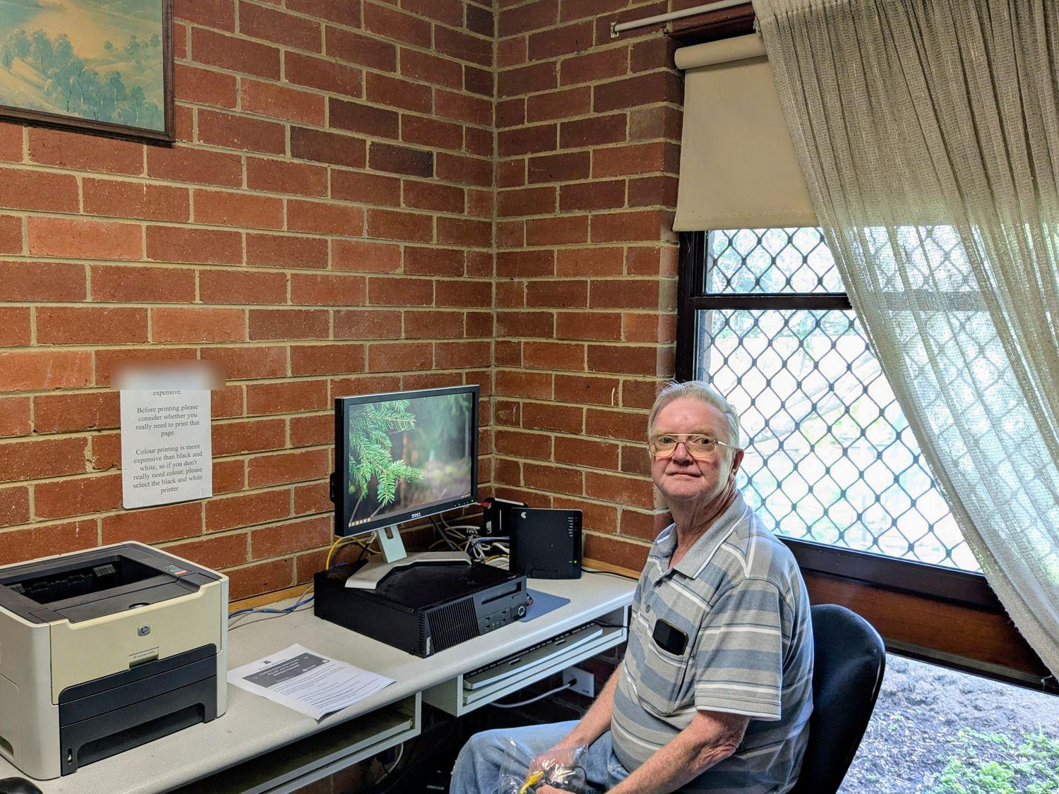 A resident using the internet kiosk computer and printer at Agg Street, Northcote